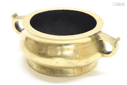 Chinese polished bronze censer, with twin ring handles raised on a low foot rim, six character