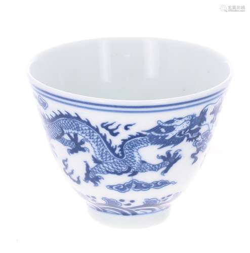 Chinese blue and white porcelain tea bowl, decorated with band of two dragons among clouds, raised