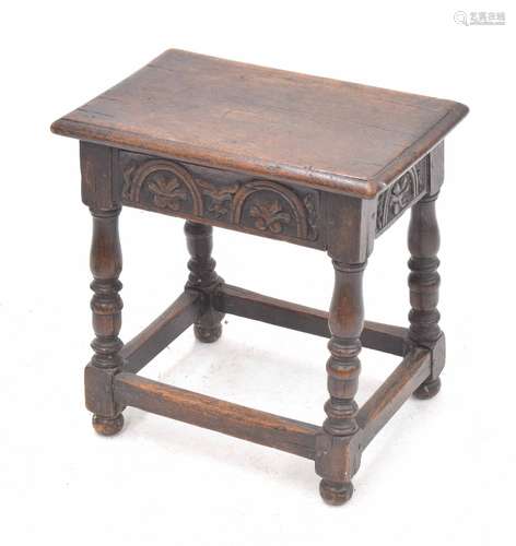 Oak joynt stool, with moulded top over carved frieze, on turned legs united by stretchers, 18