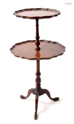 Georgian style mahogany two tier dumb waiter, with piecrust moulded rims, on a turned support raised