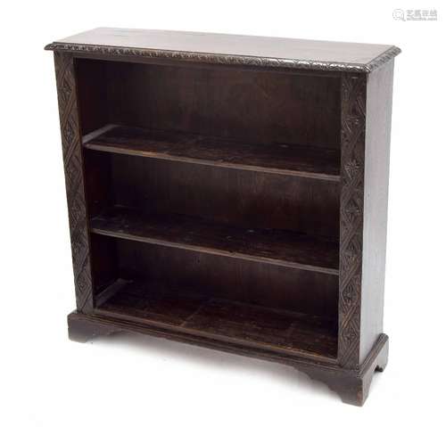 19th century carved dark oak open bookshelf, with two shelves flanked by carved foliate pilasters