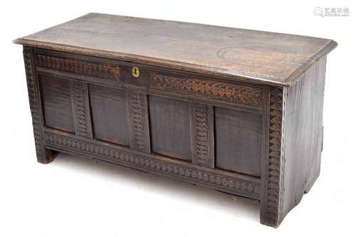 17th century carved oak coffer, the hinged moulded top over four panel front with repeated motif