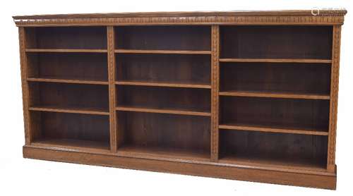 Large narrow oak open shelved bookcase with carved decoration, 109