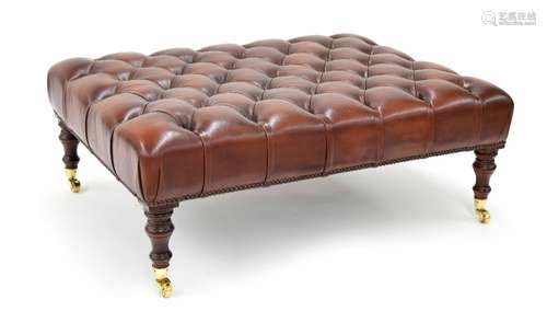 Good leather button upholstered hearth stool, raised on turned supports terminating in brass