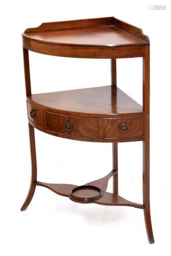 George III mahogany three tier bowfront corner washstand with a central short drawer flanked by