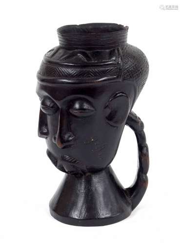 Congolese Kuba carved wine cup, with three typical stylised faces and figural handle, 8.5