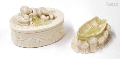 Belleek porcelain sleeping cherub oval trinket pot and cover, factory stamp and reg no. 0857