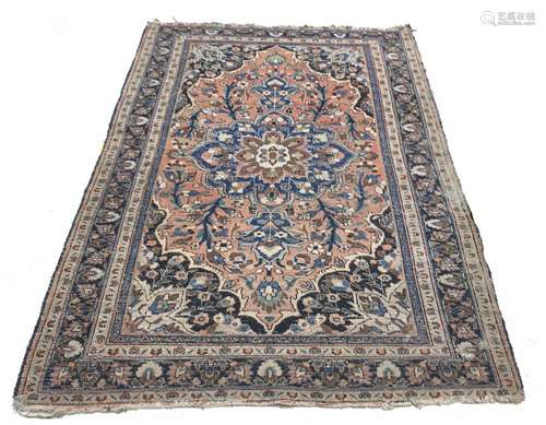 Persian pink ground rug, decorated with large flowerhead medallion to the centre within a central