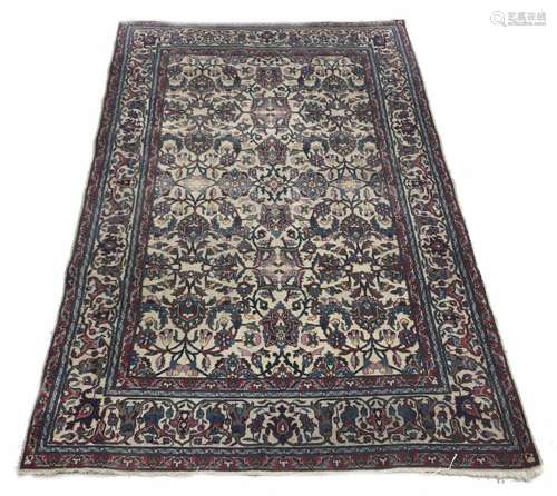 Persian allover patterned rug, navy on a natural ground decorated with close foliate scrolling motif