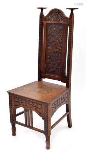 Arts & Crafts carved oak hall chair, the tall arched back with two candle platforms over plain