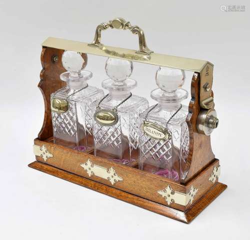 Edwardian oak and silver plate mounted tantalus for three square decanters, with Daniel & Arter