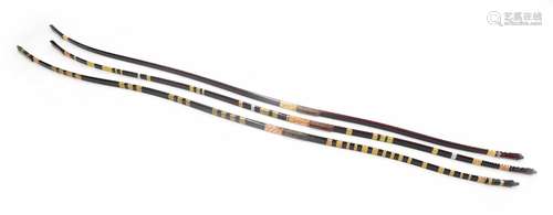 Three Japanese Yumi long-bows, two black and red lacquered, the other black lacquered, two with