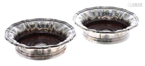 Pair of Elkington & Co. silver plated wine coasters, with shaped wavy rims around turned hardwood