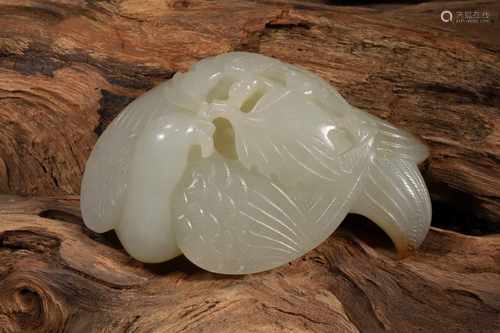 A HETIAN JADE CARVING DEPICTING A PHOENIX INHABITING A BRANCH