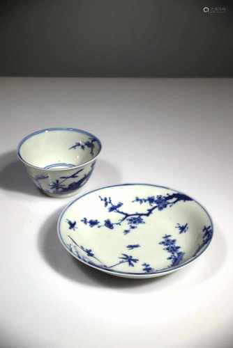 A BLUE AND WHITE CUP AND SAUCER
