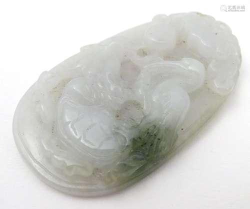 An Oriental carved jade pedant depicting stylised birds, figure etc. 2