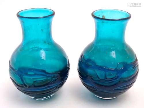 An early 20thC pair of turquoise art glass hyacinth vases, each decorated with abstract banding
