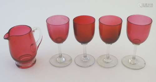 Glass: a set of four Cranberry wine glasses, together with a Cranberry glass jug. The largest 5
