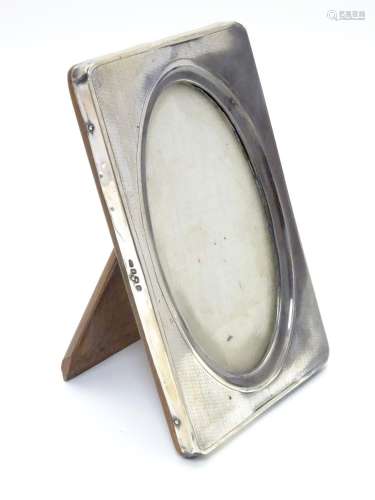 A photograph frame with Silver surround having engine turned decoration. Hallmarked Birmingham 1919.
