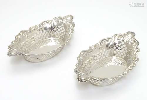 A pair of silver plate bon bon dishes with pierced decoration. Approx. 6? long. Please Note - we