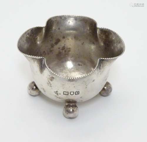 A Victorian silver salt of quatrefoil shape raised on four spherical feet. Hallmarked London 1898