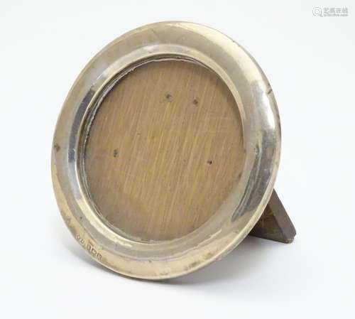 A photograph frame of circular form with silver surround. Hallmarked Birmingham 1920 maker