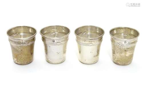 A set of four French silver tot cups with crossing ribbon decoration. Bear the French assay mark for