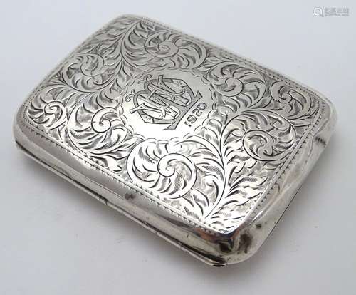 A silver cigarette case of shaped form with engraved acanthus scroll decoration. Hallmarked