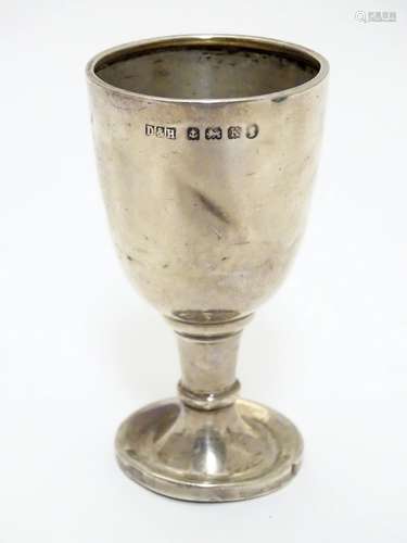 A silver egg cup of pedestal form hallmarked Birmingham 1934 with silver jubilee mark maker Deykin &