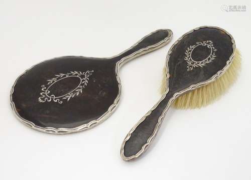 A silver and tortoiseshell backed hand mirror and brush, hallmarked Birmingham 1919 maker E S