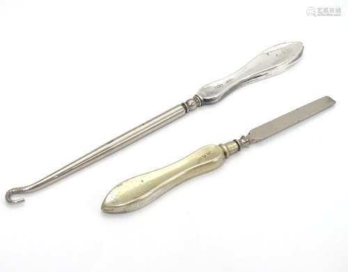 A silver handled button hook hallmarked Birmingham 1916 and a silver handled manicure tool (2)