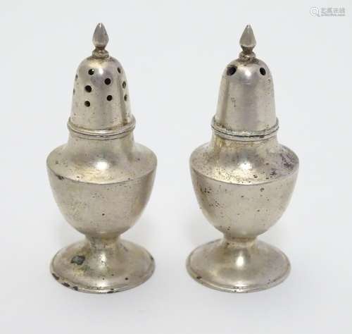 A pair of silver salt and pepper pots . Marked Sterling Hong Kong. Approx 2