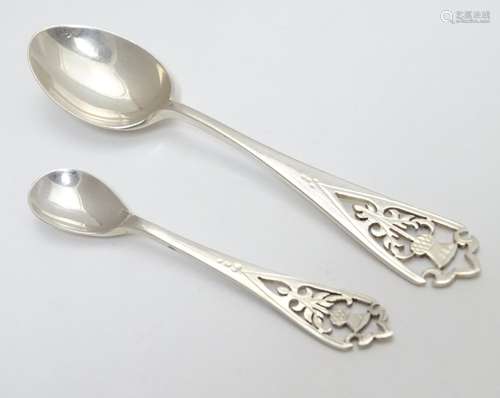 A teaspoon and a mustard spoon both with thistle decoration to handles, the teaspoon hallmarked