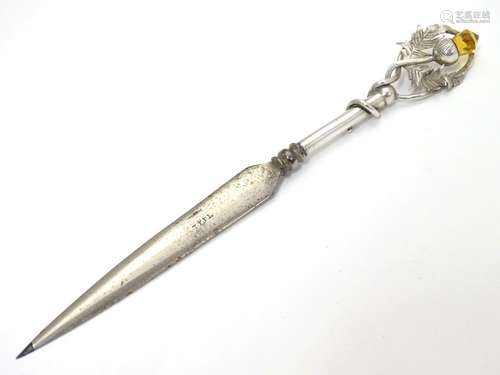 A letter opener with silver handle having thistle decoration . Hallmarked Bimirngahm1910 maker