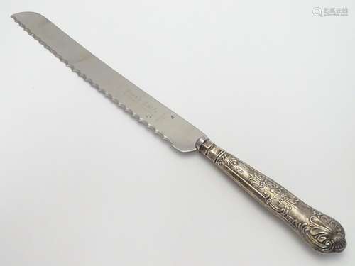 A silver handled King?s Pattern bread knife. Hallmarked Sheffield 1972 maker Harrison Brothers. 12