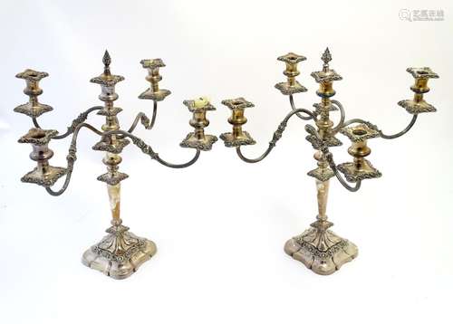 A pair of early 20thC silver plate four-branch table candelabrum / candelabra with central sconce