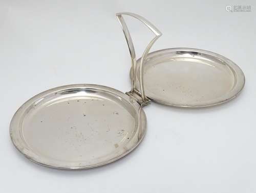 A silver plate folding cake stand by Hukin & Heath, with central handle and two circular dish formed