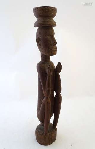 Ethnographic / Native / Tribal: A carved wooden figure of a seated man. Approx. 22