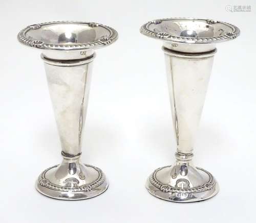 Two silver bud vases hallmarked Birmingham 1912 and 1915. The tallest 4 1/2