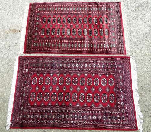 Carpet / Rug : Two red ground rugs with geometric borders and central medalion bands. 60