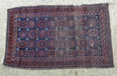 Carpet / Rug: A hand made woollen rug the blue ground detailed with geometric motiffs. Approx 59 1/