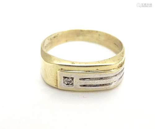 A 9ct gold ring wit yellow and white gold decoration and diamond detail. Ring size approx size S