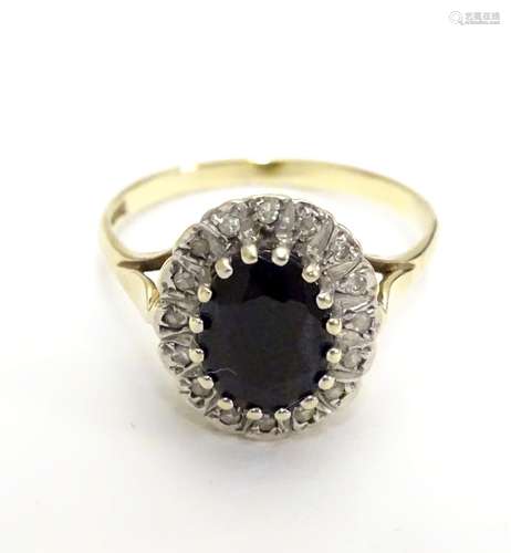 A 9ct gold ring set with facet cut blue spinel bordered by diamonds. Ring size approx N. Please Note