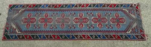 Carpet / Rug : A runner with pale blue ground with banded geometric red, brown and bright blue