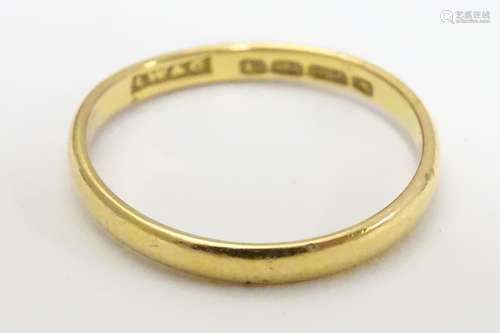 A 22ct gold band, the ring approx size M (2g) Please Note - we do not make reference to the