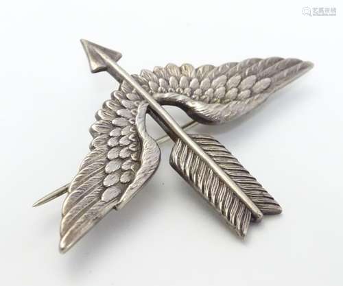 An unusual silver brooch formed as a winged bow and arrow. Hallmarked Birmingham, 1912 maker T.O.