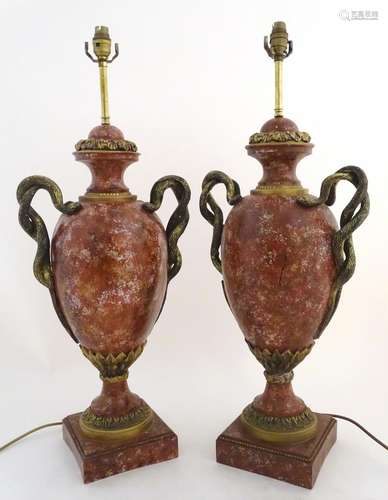 A pair of early 20thC table lamps, formed as classical urns with serpent/ snake formed handles and