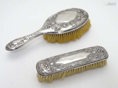 Silver backed brush with embossed decoration hallmarked Sheffield 1910 maker Walker & hall. The