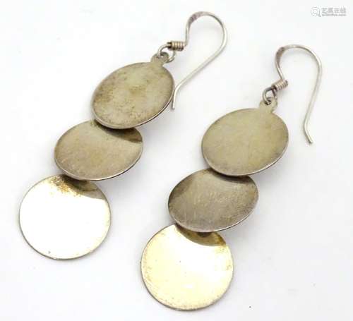 A pair of .925 silver and white metal pendant earrings with three circular discs. Approx. 2