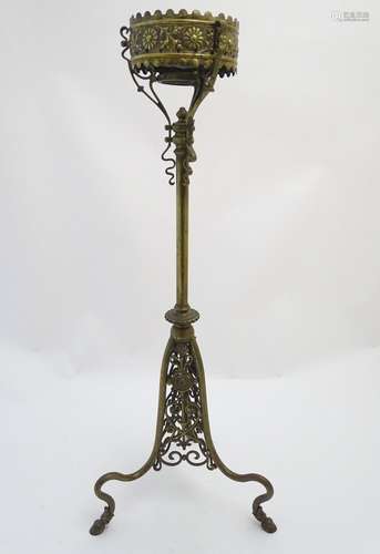 A late 19thC brass table lamp stand, of tripod form, ornately decorated with floral and scrolling